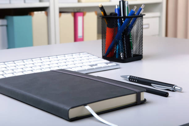 istock Business accessories on desktop: notebook, diary, fountain pen, glasses. Macro with blur and soft focus. 984439996