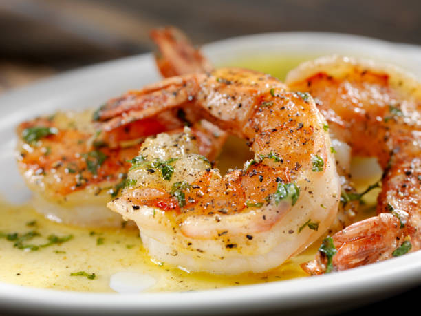 Jumbo Tiger Prawn Scampi Jumbo Tiger Prawn Scampi poached in Butter and Herbs Shrimp Scampi stock pictures, royalty-free photos & images