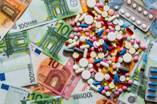 colorful pills tablets drugs on money background. Flat lay.