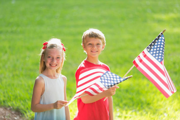 istock Children, siblings, holding american flags 984452940