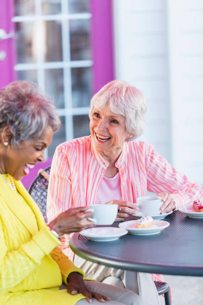istock Two multi-ethnic senior women talking over coffee 984471630