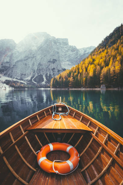 istock Traditional rowing boat on a lake in the Alps in fall 984476084