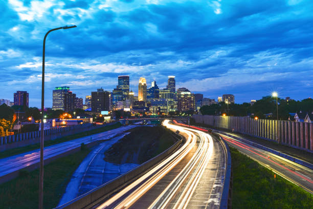 istock Minneapolis Skyline at Sunset with Traffic Light Trails 984498022