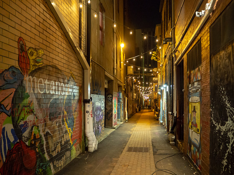 Strong Street Lights and Graffiti Art, Knoxville, Tennessee, United States of America, summer 2018: [Night life in the center of Knoxville]