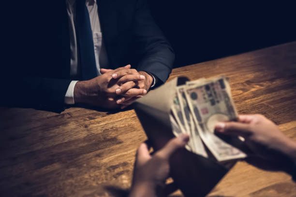 Businessman counting money, Japanese yen currency, in the envelope Businessman counting money, Japanese yen currency, in the envelope just given by his partner after making closing a deal in dark private room corruption stock pictures, royalty-free photos & images