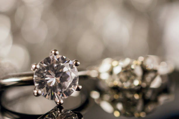 istock Luxury Jewelry diamond rings with reflection on black background 984519644