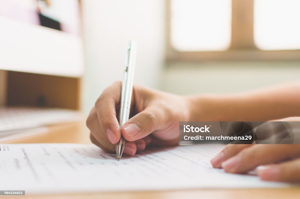 Businessman hand signing the document business contract agreement Police Statement Stock Photo