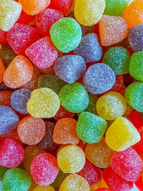 a pile of gumdrops with sugar crystallized - sweet food sugar vibrant color multi colored imagens e fotografias de stock