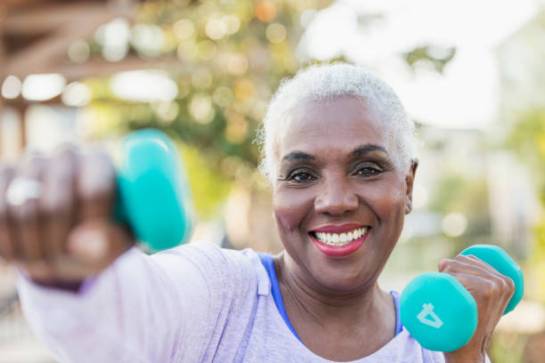 istock Senior African-American woman lifting hand weights 984548042