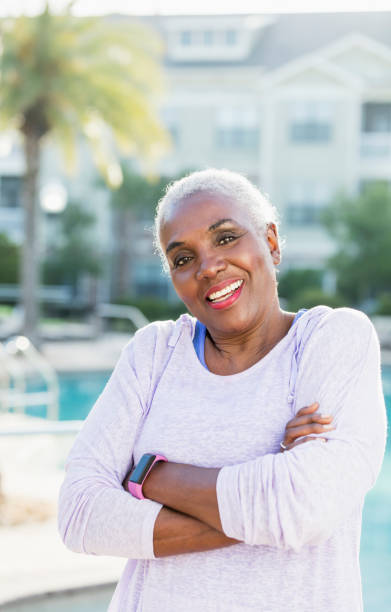 istock Senior African-American woman standing on pool deck 984548082