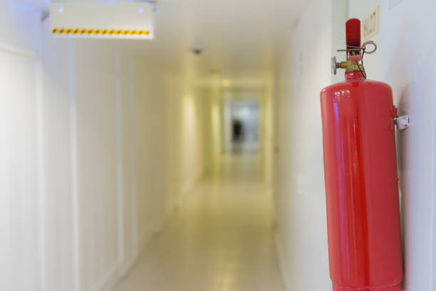 istock Fire extinguisher in front of room at apartment 984588270