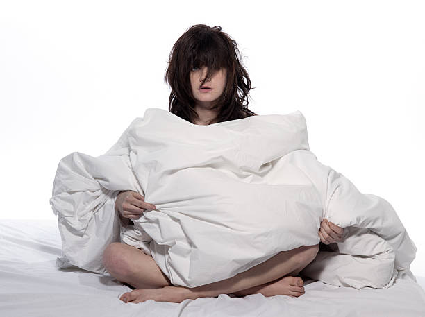 istock A woman with a bed head wrapped in duvet 98460559