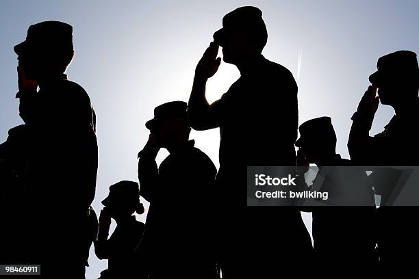 Soldiers Salute The Flag At Sunset Stock Photo - Download Image Now - Military, Saluting, Armed Forces
