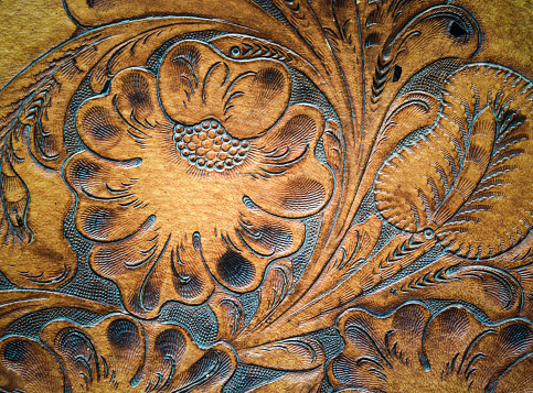 Brown leatherwork carved detail on saddle.