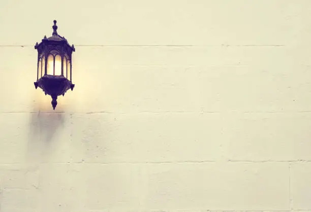 The vintage lamp on cement wall background
