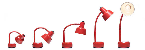 Evolution Desk lamps red color against white background. Growing up sequence in a evolution concept. desk lamp photos stock pictures, royalty-free photos & images