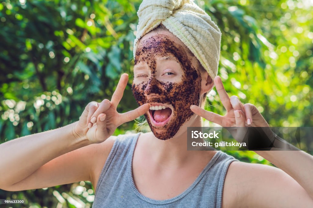Face Skin Scrub. Portrait Of Sexy Smiling Female Model Applying Natural Coffee Mask, Face Scrub On Facial Skin. Closeup Of Beautiful Happy Woman With Face Covered With Beauty Product. High Resolution Face Skin Scrub. Portrait Of Sexy Smiling Female Model Applying Natural Coffee Mask, Face Scrub On Facial Skin. Closeup Of Beautiful Happy Woman With Face Covered With Beauty Product. High Resolution. Exfoliation Stock Photo