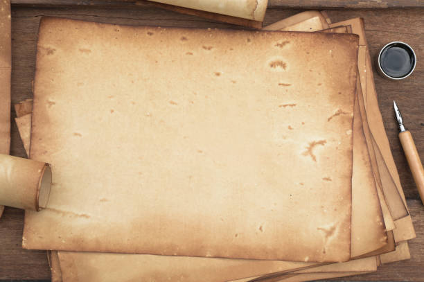 istock old paper on brown wood texture with pen and ink 984636732