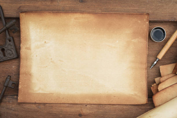 istock old paper on brown wood texture with pen and ink 984636734