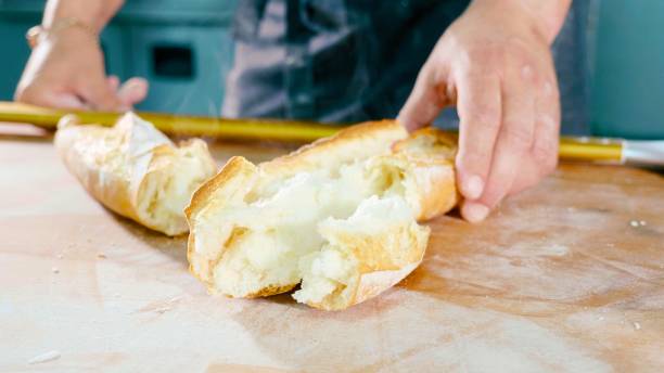 istock Breaked fresh bread on the table at commercial kitchen of bakery. 984640502