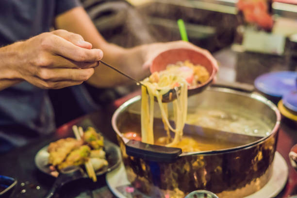 istock The man puts the soup in a plate 984641140