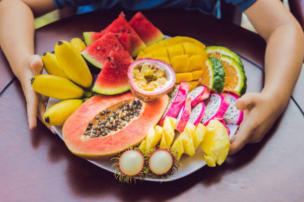 The abundance of fruit on a plate on the table The abundance of fruit on a plate on the table. 7676 stock pictures, royalty-free photos & images