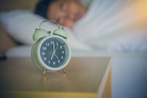 istock alarm clock on the bed in bedroom 984652954