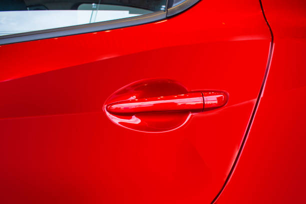 istock Car door handle red color for customers. Using wallpaper or background for transport and automotive image. 984653650