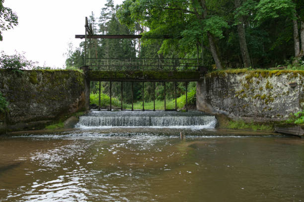 istock Old bridge, lake locks and green grass. 984657786