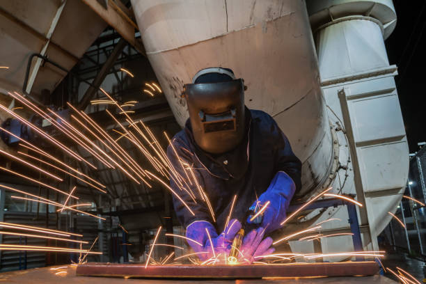 istock Industrial worker is welding in factory 984661210