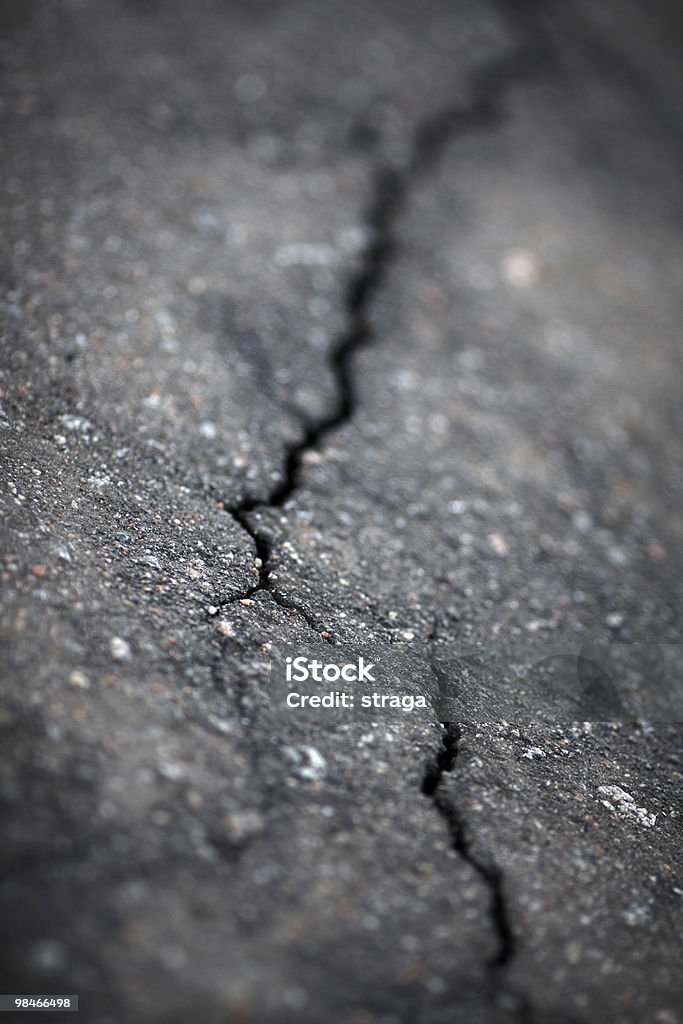 Cracked asphalt Closeup of cracks in asphalt surface by earthquake,shallow focus Asphalt Stock Photo