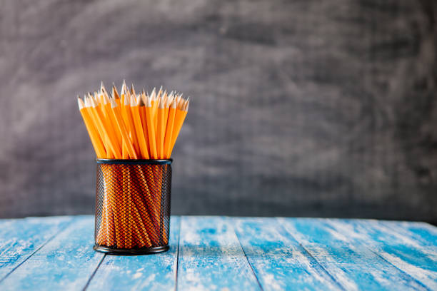 istock Yellow sharp pencil in black metal basket 984665968