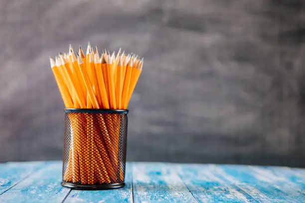 Photo of Yellow sharp pencil in black metal basket