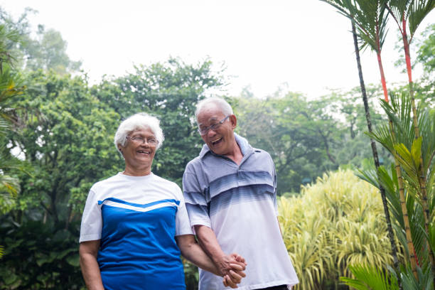istock Happy active senior couple walking in the park 984666700
