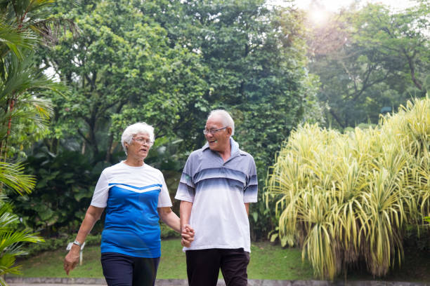 istock Happy active senior couple walking in the park 984669260