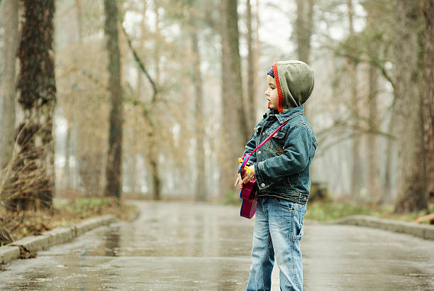 istock Boy plays guitar in rainy park 98467200