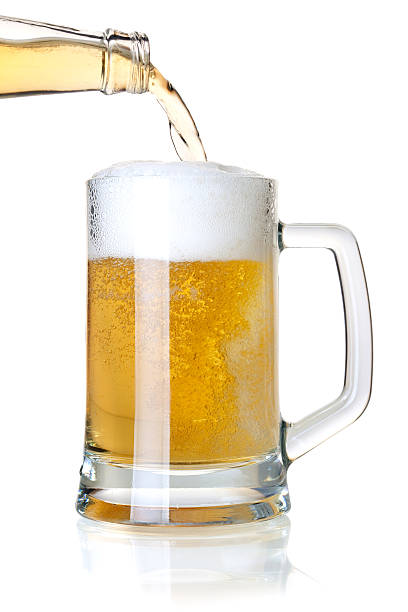 istock Beer is pouring into a glass from bottle 98468040