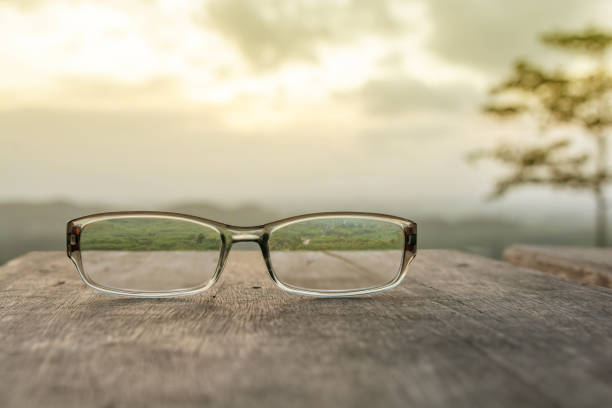 istock Eyeglasses on wooden table 984688936