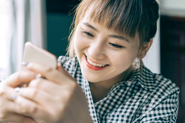 istock woman looking to her phone excitedly 984688984