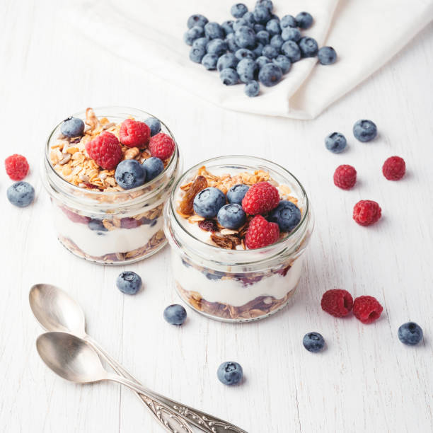 istock Granola with berries and yogurt in jars. 984689446