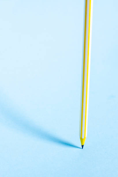 istock Yellow striped pencil stands upright 984702700