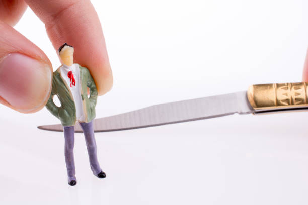 istock Hand holding a pocket knife near a figure 984709486