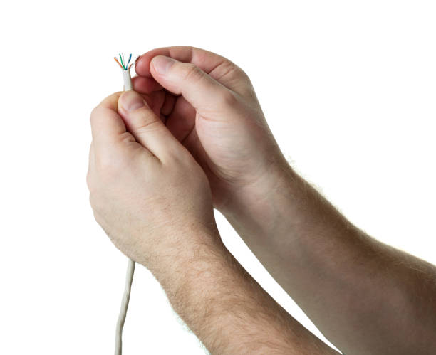 istock Human hands with Optic fiber cable, isolated on white 984711494