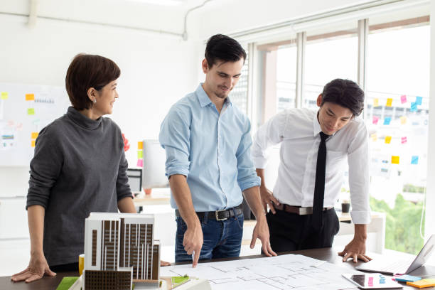 istock Male architect working with team with building project. 984719518