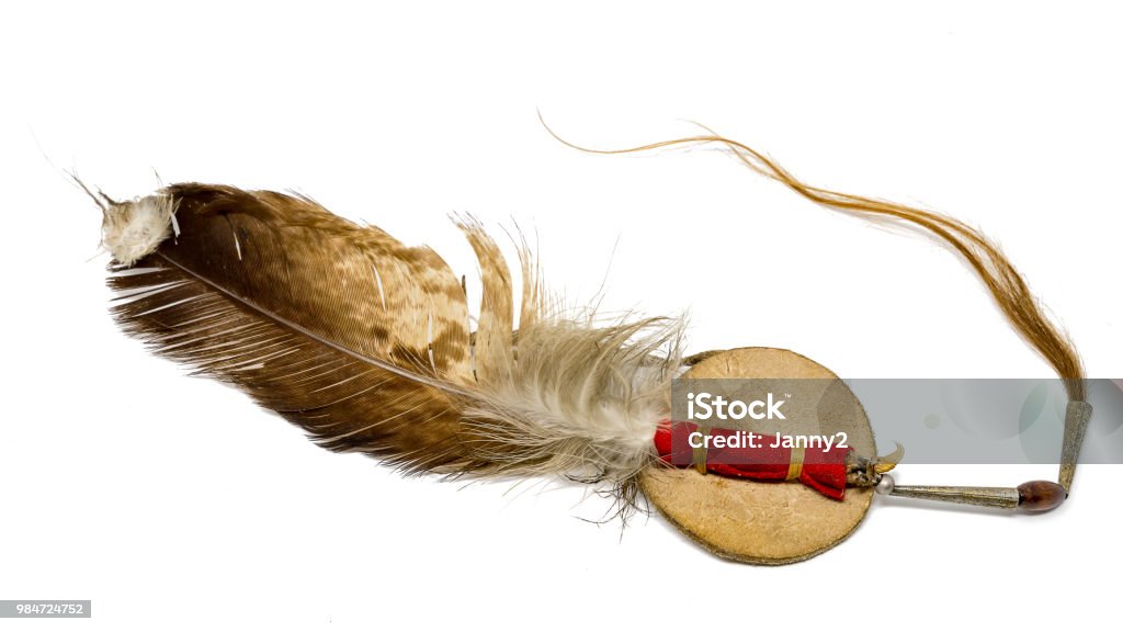 Eagle feather with horse hair as Indian hair ornament optional on white Eagle feather with horse hair as Indian hair jewelry exposed to white Feather Stock Photo