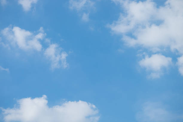 istock White Clouds on the bright sunny blue sky. Nature background. 984725638