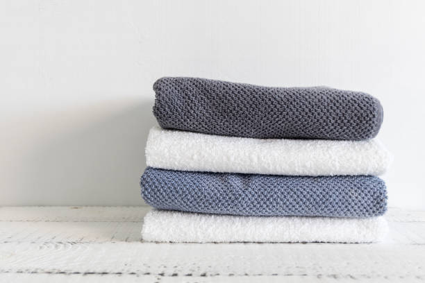istock Folded towels on a white wooden table. Spa and wellness, cotton terry textile. Ecological theme 984732294