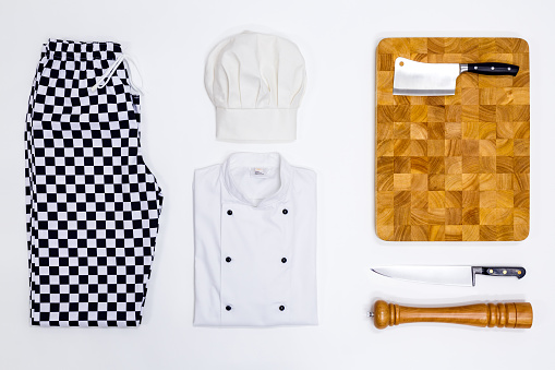 A flat lay arrangement of Chef whites uniform and equipment.