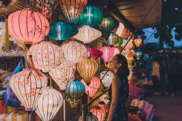 Young Caucasian woman  choosing lanterns in Hoi An