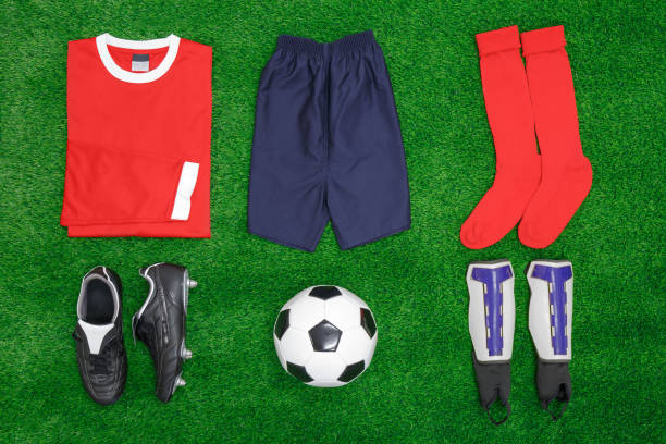 Football Soccer flat lay A flat lay arrangement of football or soccer kit on grass, with shirt, shorts,socks, boots, shin pads and ball. football socks stock pictures, royalty-free photos & images